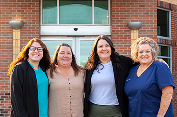Cedar County Memorial Hospital's First Oncology RNsfour CCMH nurses stand together in front of the hospital entrance