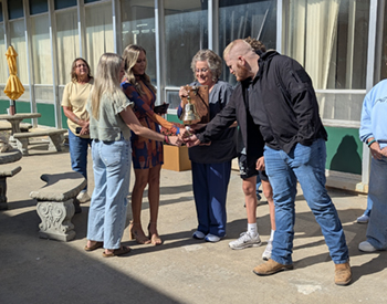 A photo of the bell donor family ringing the Bell of Hope in honor of a loved one.